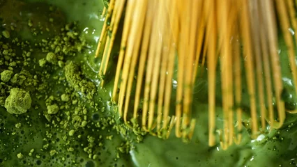 Bamboo Whisk Mixing Matcha Tea in Macro © Lukas Gojda