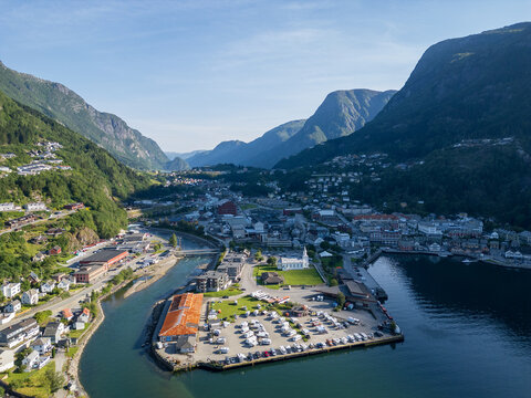 Aerial view of Odda, an industrial town on the shores of Hardangerfjord in western Norway, known as the main gateway to the iconic Trolltunga hike. The images capture the contrast between dramatic Sca