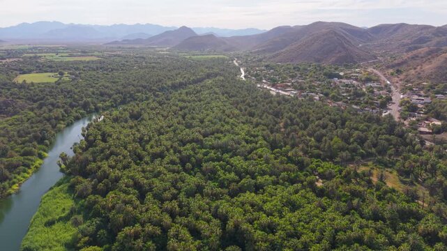 Explore aerial views surrounding the Mission of Santa Rosalia in Baja California Sur, Mexico, highlighting desert, mountains, and oasis in evening light.