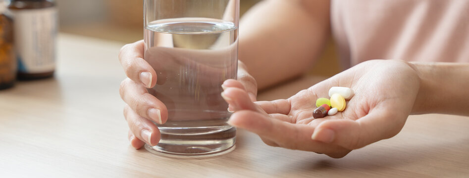 Healthcare Harmony: Close-Up Hands Holding Medication and Water Glass for Optimal Wellness, Pharmaceutical Treatment and mental health treatment