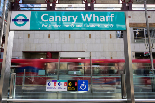 Canary Wharf DLR Station Sign with Train in London Docklands