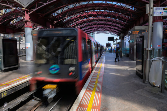 DLR Train Departing Platform at Canary Wharf Station London