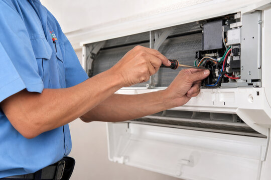 Professional HVAC Technician Servicing Split AC Unit