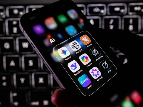 Closeup of a smartphone screen displaying a collection of popular artificial intelligence application icons including chatgpt, gemini, claude, and copilot