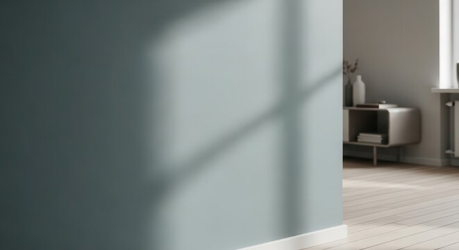 Muted matte teal wall exhibiting subtle shadows and light patterns in an interior setting.