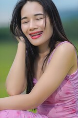 Fototapeta premium Young Woman in Pink Outfit Smiling at Sai Thong Reservoir, Thailand