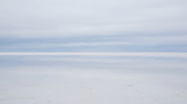 Vast Salt Flat Mirror Reflection Under Cloudy Sky