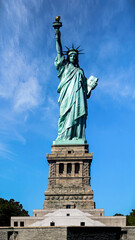 Fototapeta premium Front view of the Statue of Liberty against a clear blue sky in New York City, USA landmark and travel destination.