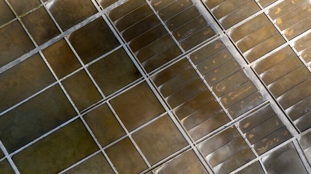 Aerial view of Salinas de Aveiro salt pans with geometric basins and stone dividers in Aveiro, Portugal.
