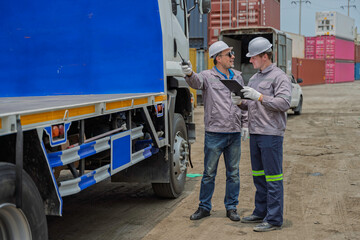 Naklejka premium Professional logistics team performing cargo inspection and safety check on truck trailer in industrial shipping port. Logistics management and commercial transport supply chain services.