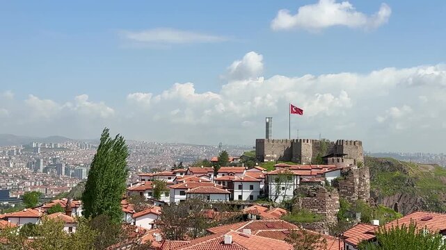The Turkish flag waves at Ankara Castle, with a view of Ankara city in the background. 4k video.
