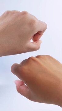 Close up comparison of different skin tones on both hands. Beauty and UV skincare concept on white background.