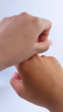 Before and after using beauty cream. Comparing two hands with different skin color. Vertical composition on white background. Skin transformation concept.