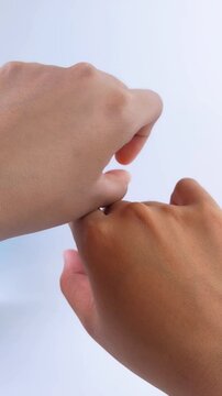 Showing skin color difference between both hands. Vertical close up on white background. Skin care concept, whitening treatment transformation.
