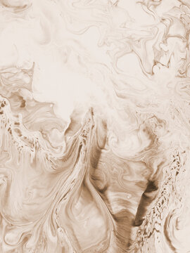 Abstract fluid art background in beige tones with marble texture and flowing acrylic paint patterns.