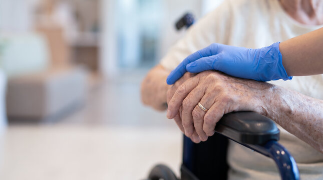 Caregiver Holding Elderly Patient Hand in Wheelchair, Compassionate Senior Care, Nursing Home Healthcare Support and Medical Assistance