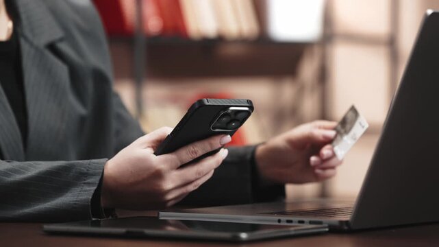 Woman entering card details on mobile phone during online transaction. Concept fintech, digital wallet and secure payment system.
