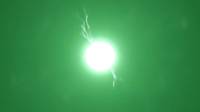 A bright glowing orb of light emits electrical energy against a green background
