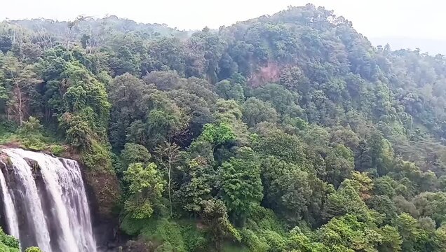 Aerial View of Curug Sewu Waterfall Surrounded by Tropical Rainforest in Central Java Indonesia