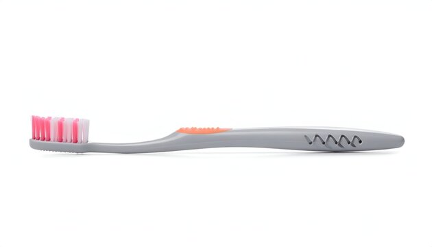 Gray toothbrush with pink & white bristles and orange accents on a white backdrop