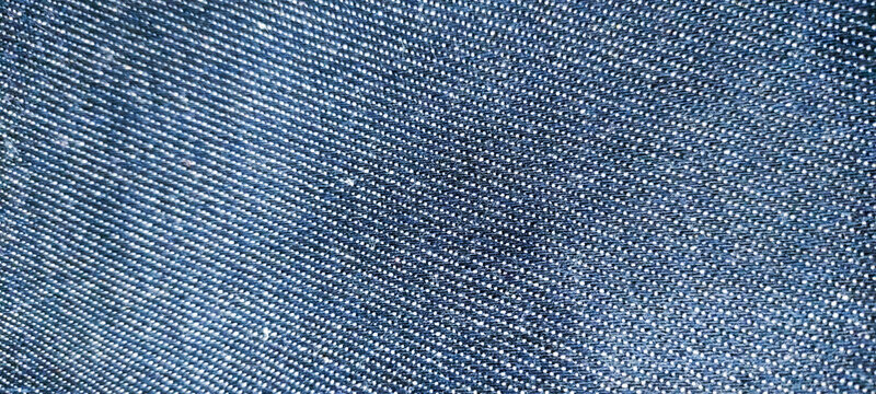 Close-up texture of dark blue denim fabric background

