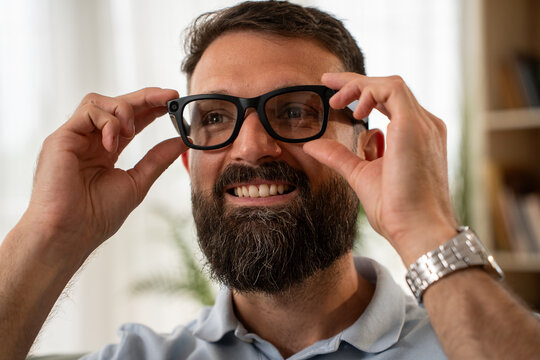 Young bearded man using ar smart glasses exploring new technology concept
