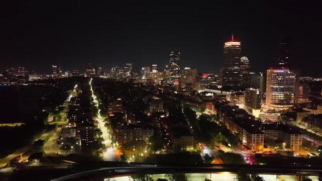 Boston Skyline at Night, Aerial Drone View of Illuminated City Skyscrapers and Downtown Buildings, Financial District Waterfront Harbor Cityscape Evening Lights in Massachusetts, USA