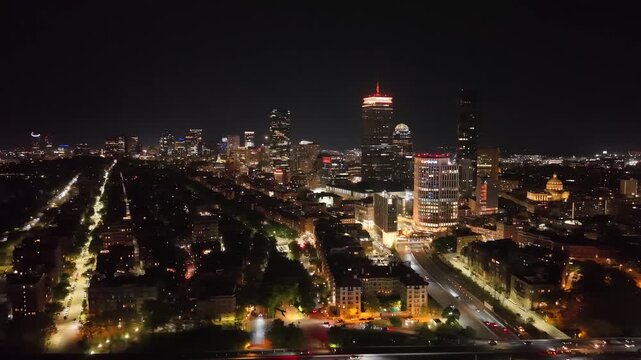 Boston Skyline at Night, Aerial Drone View of Illuminated City Skyscrapers and Downtown Buildings, Financial District Waterfront Harbor Cityscape Evening Lights in Massachusetts, USA