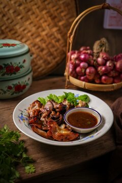 Thai grilled pork chitterlings served with spicy dipping sauce.