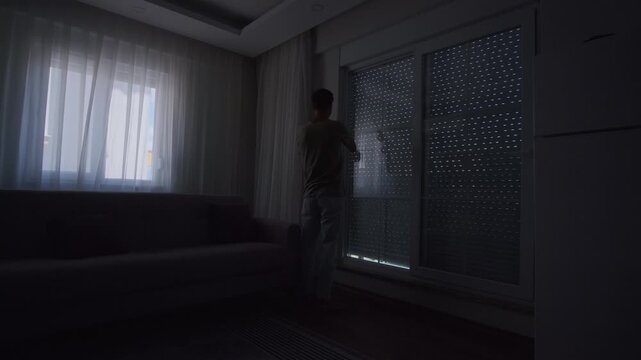 Closing blinds in dark apartment, emotional isolation and mental health concept with cinematic shadows and lonely home atmosphere