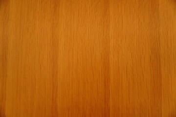 Fototapeta premium Top view of a polished light brown wood grain surface with uniform vertical patterns and warm amber tones