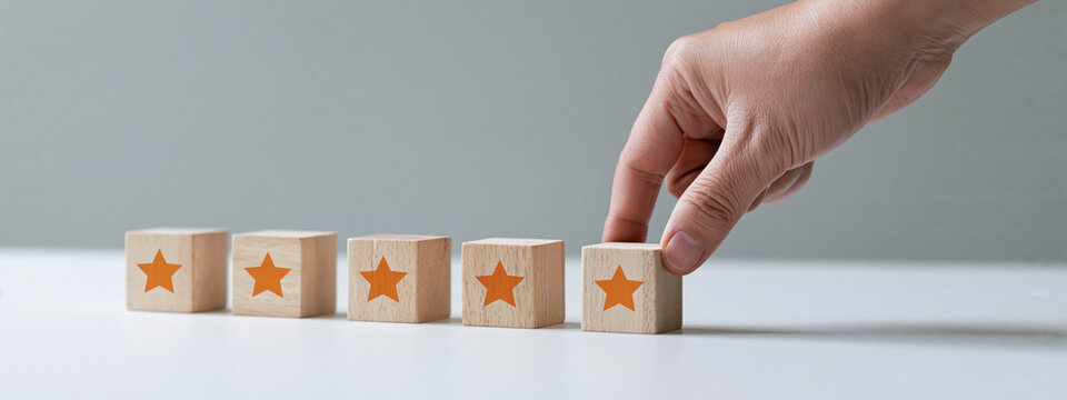 Hand gives five star rating with wooden blocks, excellent service quality concept