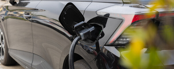 Plakat Electric car charging station. Hybrid car Electric charger station in the Car Park. Electric car charging on parking and charging station. Electric socket. Transportation EV