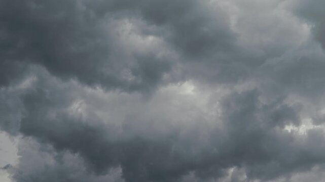 Timelapse with dark clouds gather overhead as stormy weather approaches the city during the late afternoon