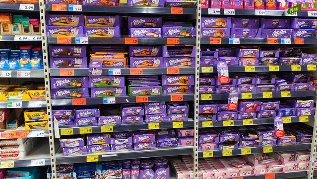 Hagen, Germany &mdash; May 20 2026: various chocolate bars and packages of Milka brand on display shelves inside a Kaufland supermarket in Hohenlimburg.