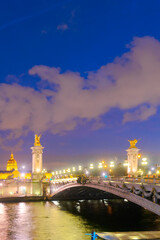 Fototapeta premium view of famouse Alexandre III Bridge illuminated at night, Paris, France