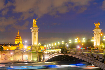 Fototapeta premium view of famouse Alexandre III Bridge illuminated at night, Paris, France
