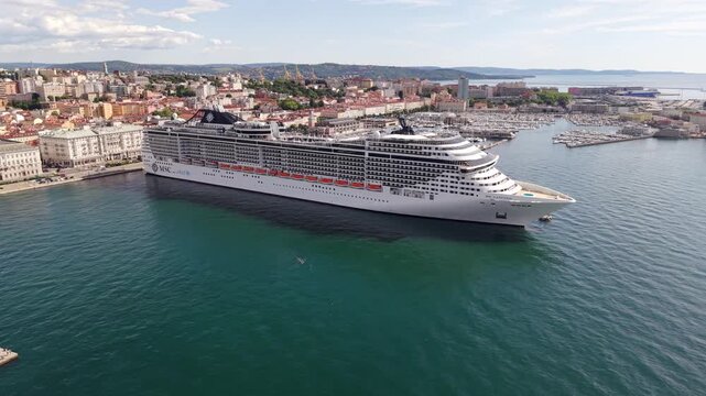 TRIESTE, ITALIA - 21 MAGGIO 2026: Veduta aerea della nave da crociera MSC FANTASIA ormeggiata alla Stazione Marittima con lo sfondo del panorama cittadino