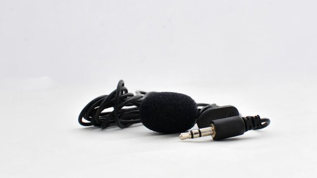 Close-up of lavalier microphone on smooth surface, ready to capture audio with elegance and precision.
