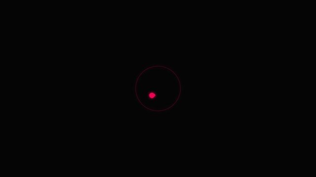 A red dot is targeted within a circle on a dark background.