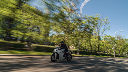 Biker riding sportbike at high speed on urban road © Chris M