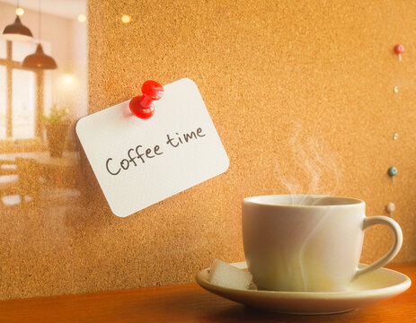 Hot Steaming Coffee Cup with Note on Corkboard in Cafe