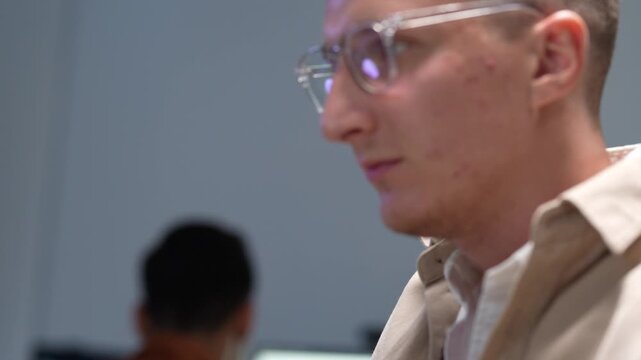 Professional software developer focusing on complex system code and data analysis in a high-tech modern office environment, demonstrating technical expertise.