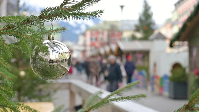 Christmas Tree Ornament Close Up with Blurred Holiday Market Background