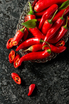 Red hot chili peppers on a silver tray.