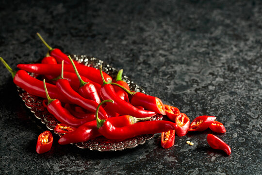 Red hot chili peppers on a silver tray.