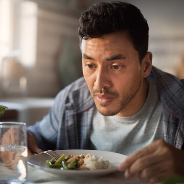 Man experiencing anhedonia while eating in a clinical laboratory setting for early detection using epigenetic clock and monocyte aging as mental health biomarker