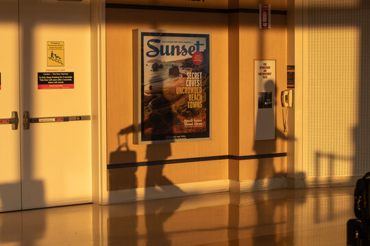 San Jose, CA, USA - Nov 29, 2023: Shadows of travelers with their carry-on luggage on the wall at San Jose Mineta International Airport.