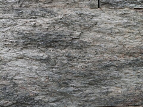 Layered Granite Wall Displaying Mineral Richness And Textured Ruggedness