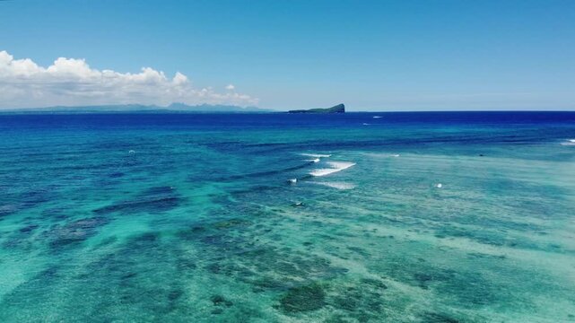 A stunning aerial view of Gunner&rsquo;s Quoin, also known as Coin de Mire Island, Mauritius. The image showcases dramatic volcanic cliffs surrounded by deep blue ocean waters, highlighting the island&rsquo;s bre